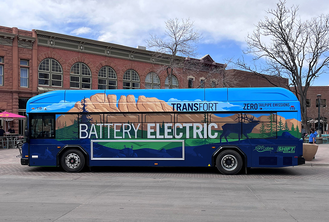 An electric bus sits is front of Old Town Fort Collins.