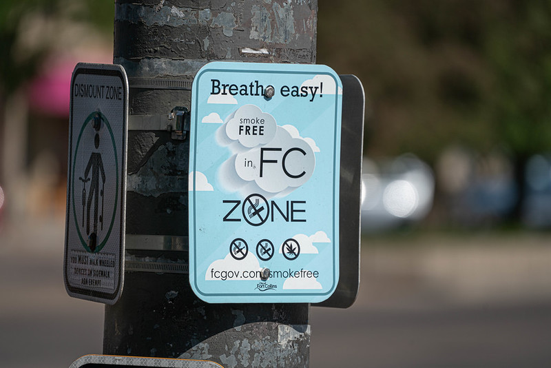 Sign on pole saying Breathe Easy! Smoke Free in FC Zone fcgov.com/smokefree