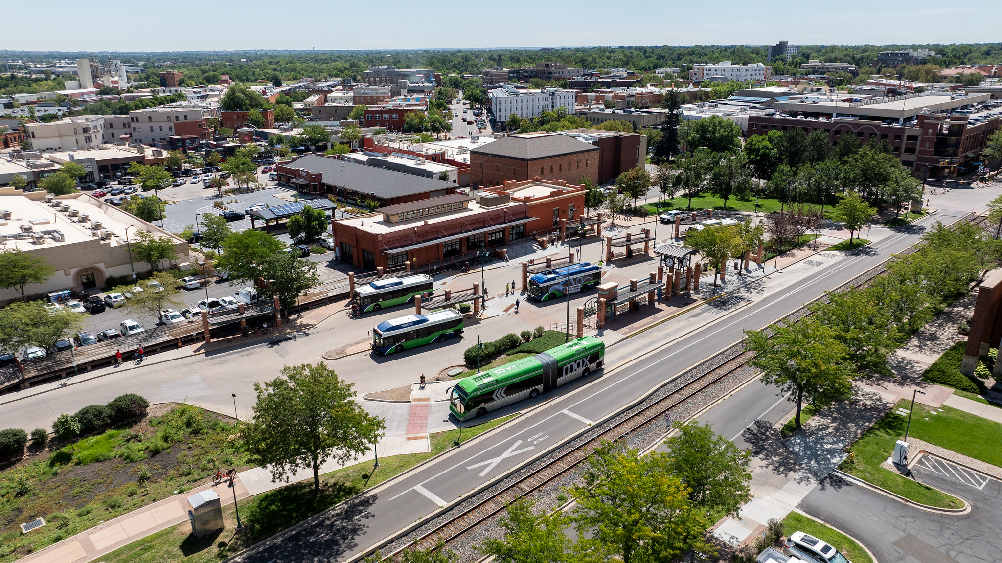 An aerial image of a transit center with buses and pedestrians in view.